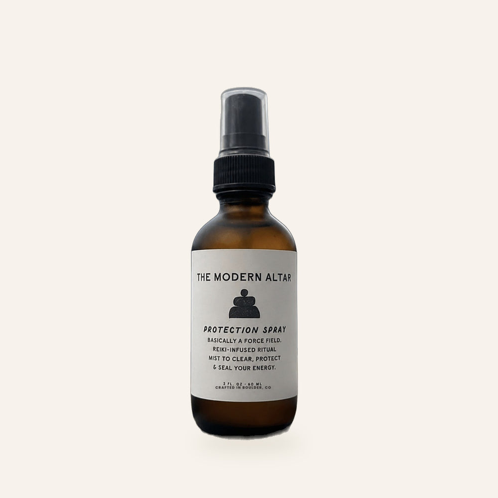 The Modern Altar Protection Spray, 2 oz amber glass bottle with black mist sprayer, on a cream background