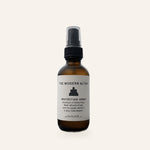 The Modern Altar Protection Spray, 2 oz amber glass bottle with black mist sprayer, on a cream background